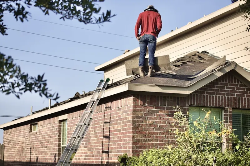 Professional roofer working on a residential roof in Treelake